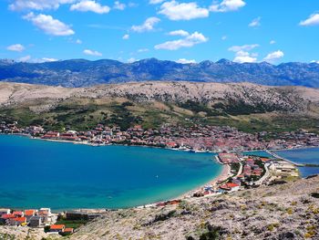 High angle view of townscape by sea against sky