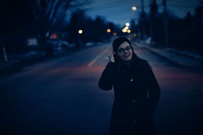 Portrait of young man standing at night