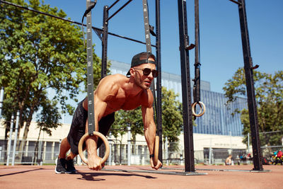 Full length of young woman exercising at park