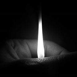 Close-up of human hand against black background