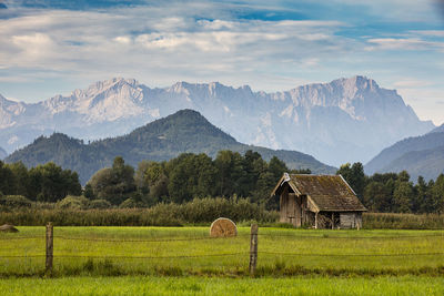 Scenic view of field and mountains against sky