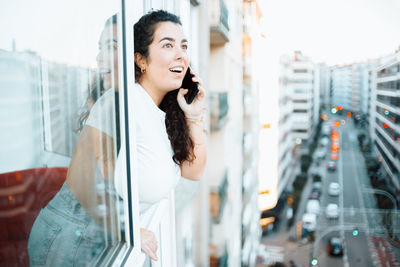 Young woman talking on phone at office