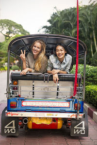 Young women in rickshaw, bangkok, thailand