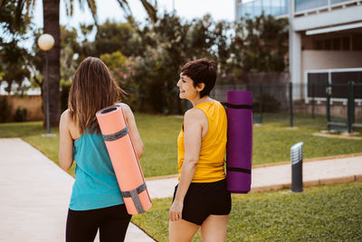 Rear view of woman exercising in park