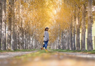 Full length of man standing in forest