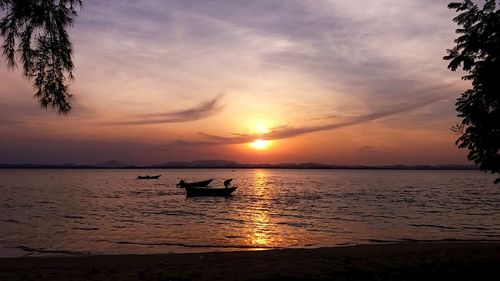 Scenic view of sea against dramatic sky during sunset