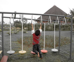 Full length of boy with arms raised