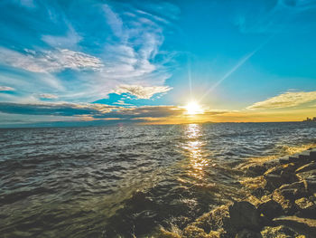 Scenic view of sea against sky at sunset