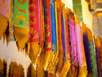 Close-up of multi colored umbrellas hanging at market stall