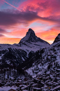 Scenic view of snowcapped mountains against sky during sunset