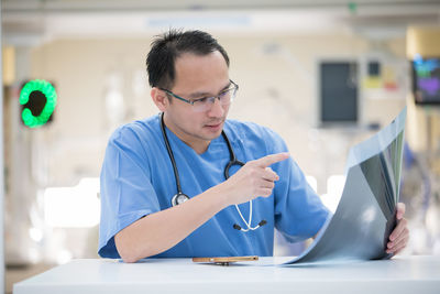 Midsection of man using mobile phone