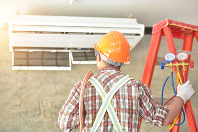 Rear view of man working at construction site