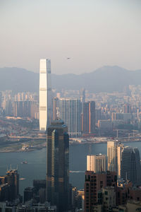 Skyscrapers in city at sunset