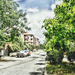 Empty road along buildings