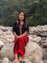 Young woman sitting on rock