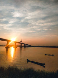Silhouette bridge against sky during sunset