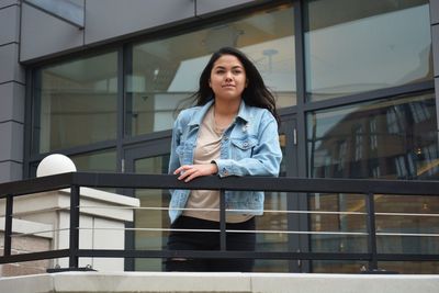 Young woman standing in balcony