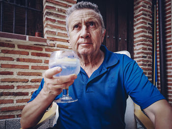 Retiree tasting a combination of premium gin with tonic water