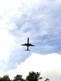 Low angle view of airplane flying in sky