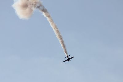 Low angle view of airplane against sky