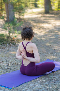 Young woman doing yoga outdoors in the park