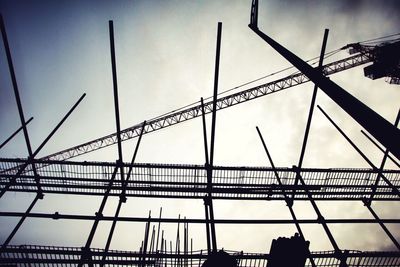 Low angle view of silhouette bridge against sky