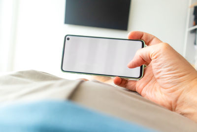 Midsection of man using mobile phone