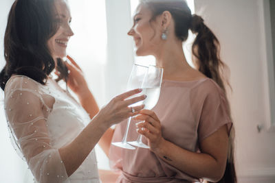 Midsection of a woman drinking glass