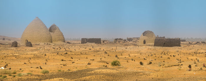 Dongola, sudan, panorama of a weathered cemetery in the desert near old dongola with several tombs