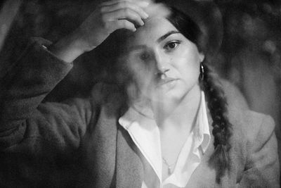 Close-up portrait of young woman looking away from inside a car