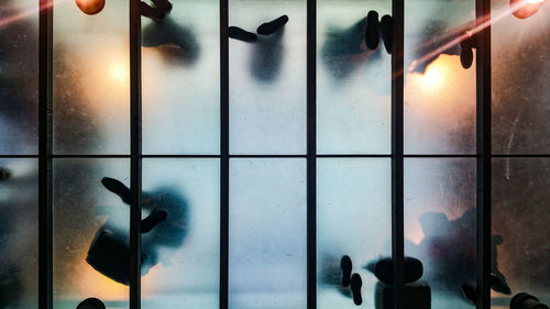 Low angle view of people standing on transparent floor