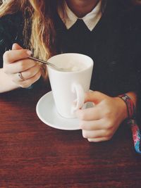 Close-up of hand holding coffee cup