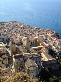 High angle view of townscape by sea against sky