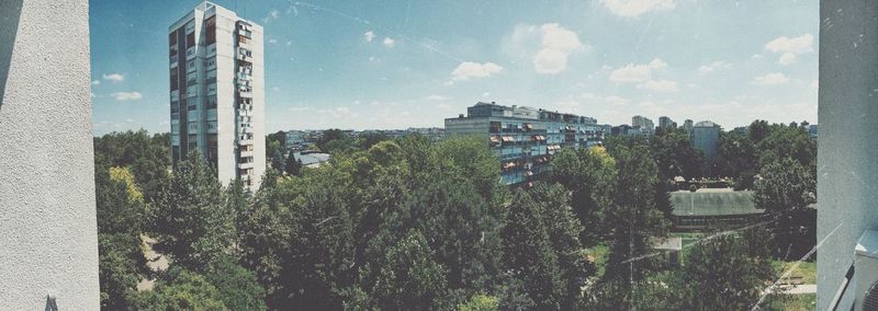 High angle view of trees and buildings against sky