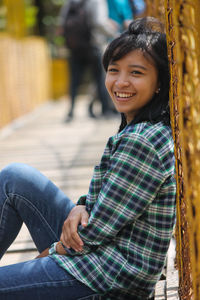 Portrait of smiling woman sitting outdoors