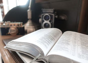 Close-up of open book on table at home