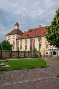 Lawn by building against sky