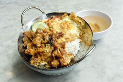 Close-up of egg with chicken and rice
