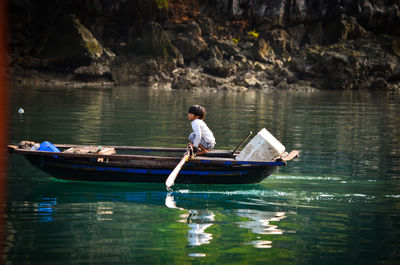 People sitting on boat in lake