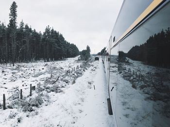 Scenic view of train on tracks during winter