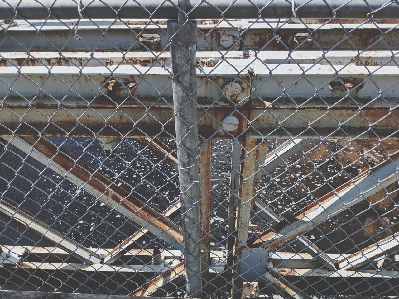 FULL FRAME SHOT OF CHAINLINK FENCE WITH METAL STRUCTURE
