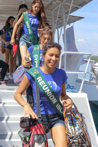 Full length portrait of smiling young woman