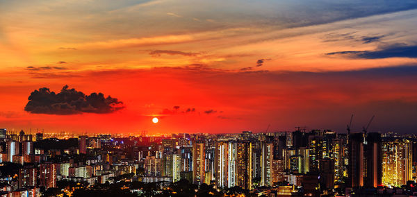 High angle view of illuminated buildings against sky during sunset