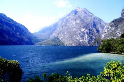 Scenic view of lake with mountains in background
