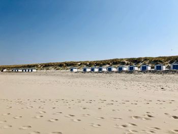 Scenic view of beach against clear blue sky