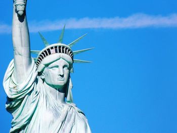 Statue of liberty against blue sky