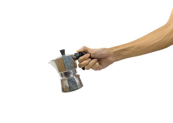 Close-up of hand holding coffee over white background