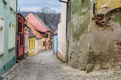 Narrow alley amidst buildings in town