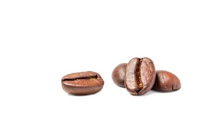 Close-up of coffee beans against white background