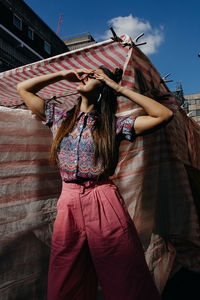 Midsection of woman standing in traditional clothing